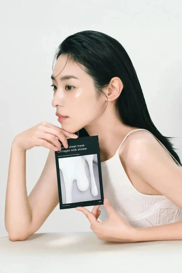 Lifestyle image of a model holding Abib Gummy Sheet Mask Collagen Milk Sticker pack against a clean background, anti aging collagen face mask keyword for SEO