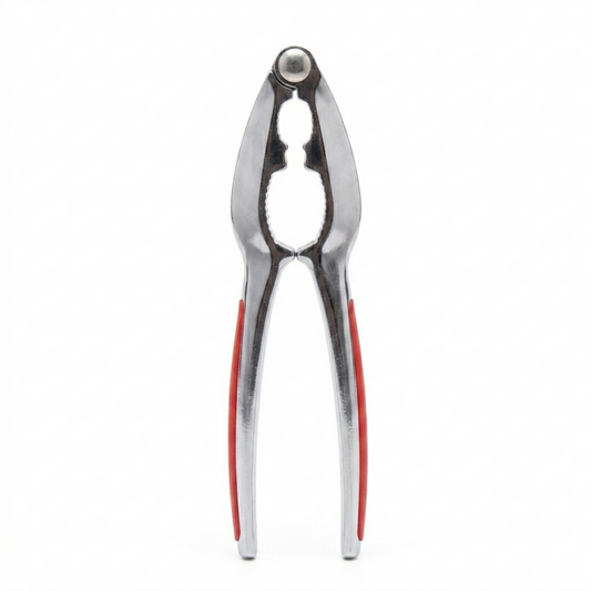Metallic kitchen Nutcracker with red accents on a white background