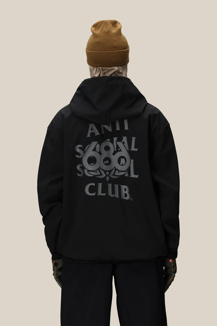 A person wearing a brown beanie, dark pants, gloves, and the 686 Men's ASSC F1 Waterproof Team Hoody by 686, featuring Anti Social Social Club branding and a back graphic, stands facing away against a plain beige background.