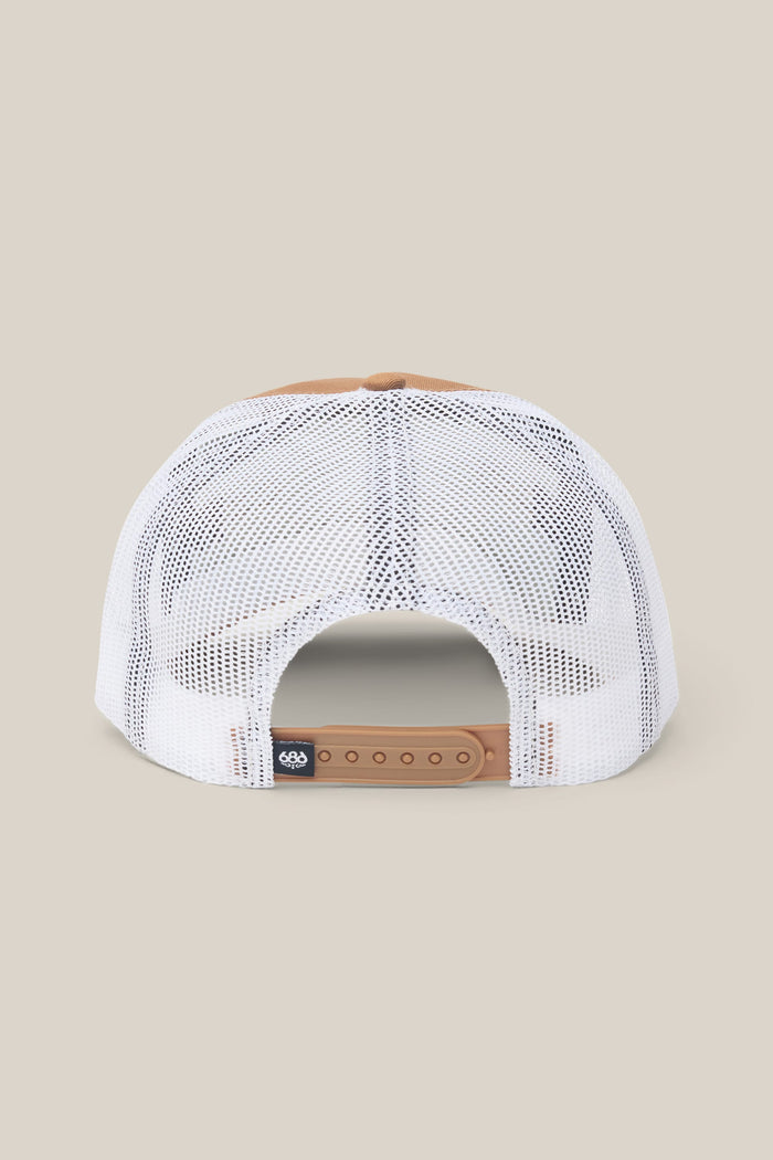 The 686 Mid-Pro Wreath Unstructured 5 Panel Mesh Hat by 686 is shown from the back in tan and white, featuring an adjustable tan snapback closure and a small black tag on the left side. This men’s hat is crafted from a durable and comfortable polyester-cotton woven fabric.