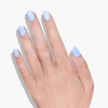 A hand with neatly manicured nails painted in LONDONTOWN’s Amalfi Love, a cool blue polish, against a white background for fresh beach vibes.