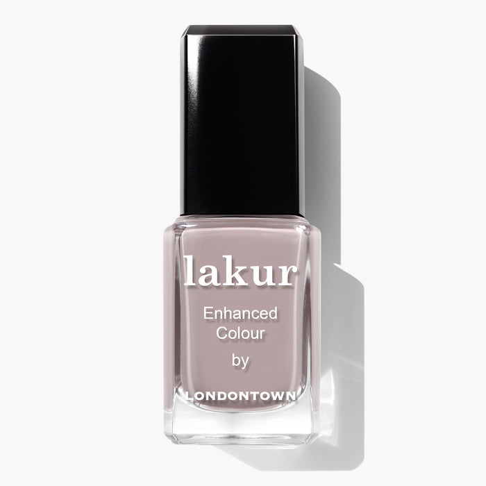 A close-up image of a bottle of LONDONTOWN's Beaumont nail polish, showcasing a dusty mauve-nude shade with a black cap and white text on the label. This vegan and cruelty-free formula blends style with conscientious beauty.