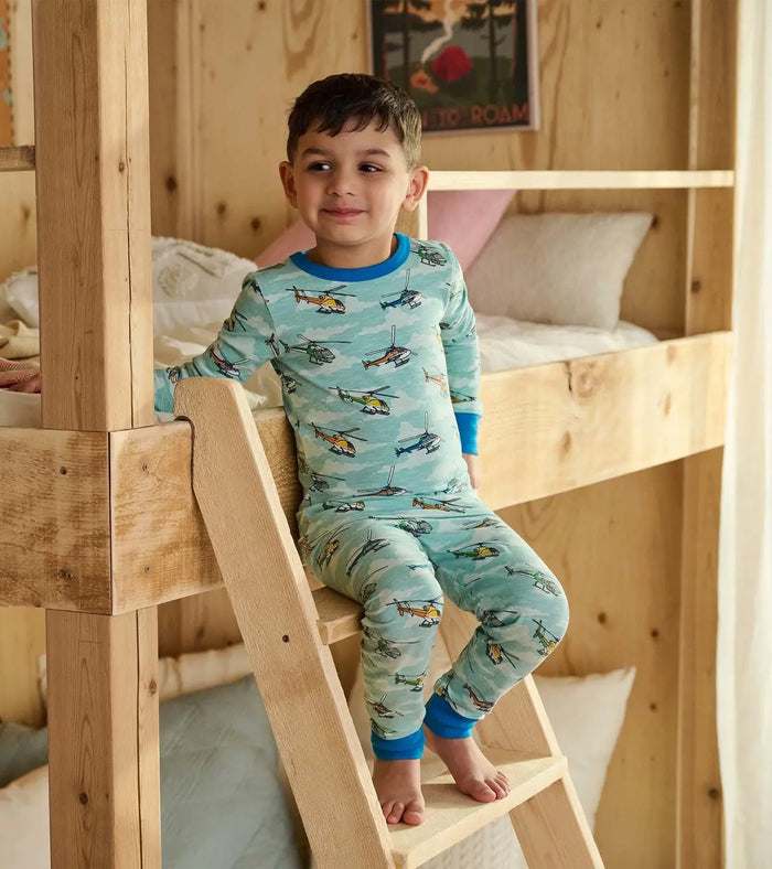 Boy wearing Hatley helicopter long sleeve pajamas with soft organic cotton stretch fabric.
