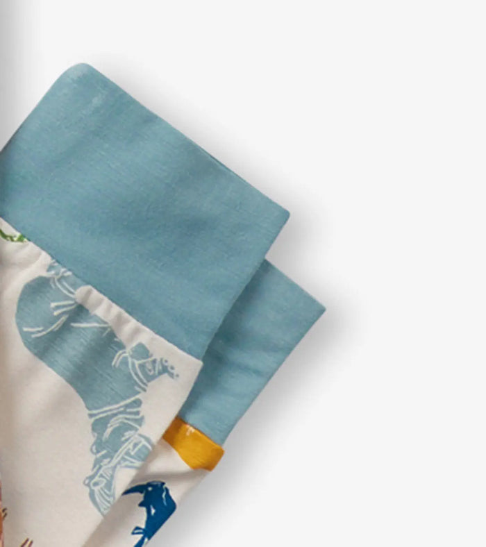 Detail of cuffed sleeve and soft bamboo stretch fabric on boys safari pajama set.