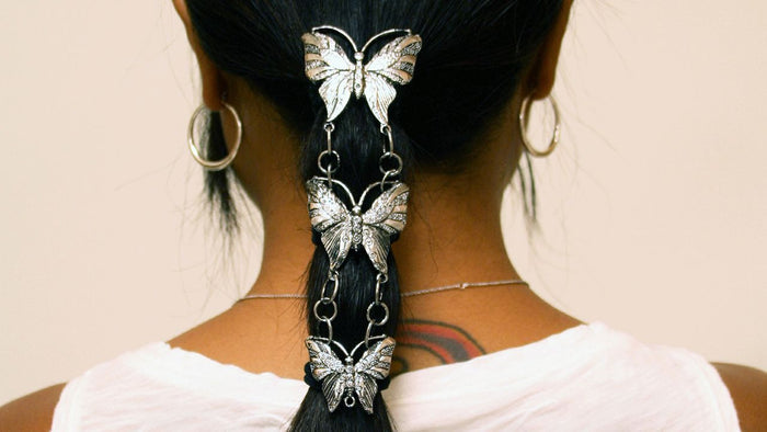 Close-up of model wearing Silver Butterfly Hair Armor ponytail holder, elegant hair accessory