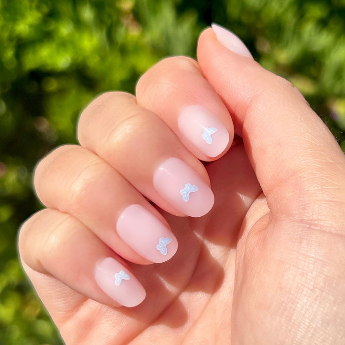 Butterfly Party | Round | Extra Short press-on nails with soft pink base and delicate purple butterfly accents for quick mani
