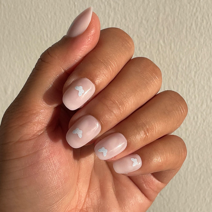 Butterfly Party | Round | Extra Short press-on nails with pale pink base and white butterfly accents for a quick mani