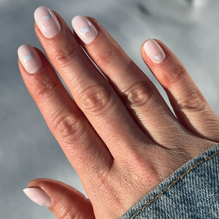 Butterfly Party | Round | Extra Short press-on nails with pale pink base and subtle purple butterfly details for a quick mani