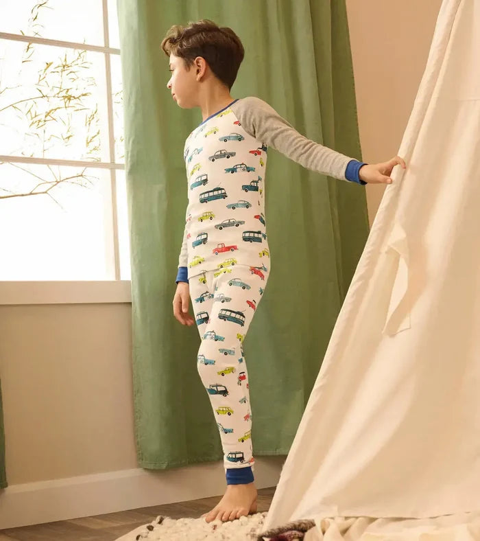 Boy wearing Hatley Cars Raglan pajamas with soft organic cotton and snug-fitting comfort.