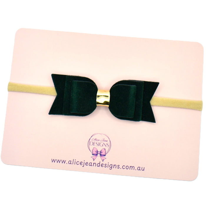 Green velvet bow headband on a pink backing card with Alice Jean Designs branding