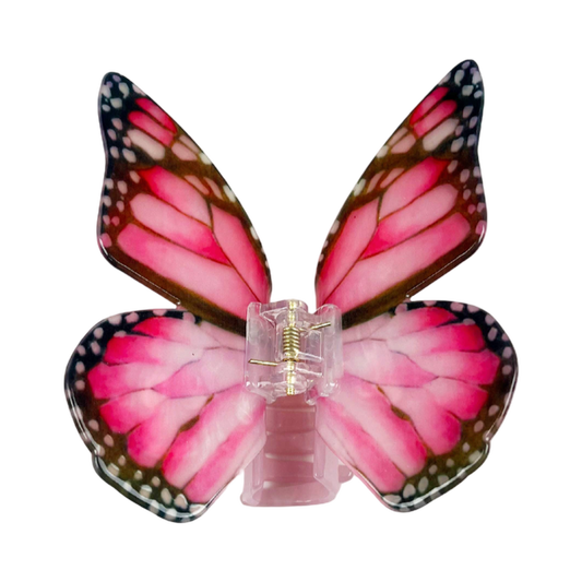 Dark pink acetate large butterfly-shaped hair claw clip with sculptural wings and a secure claw closure.