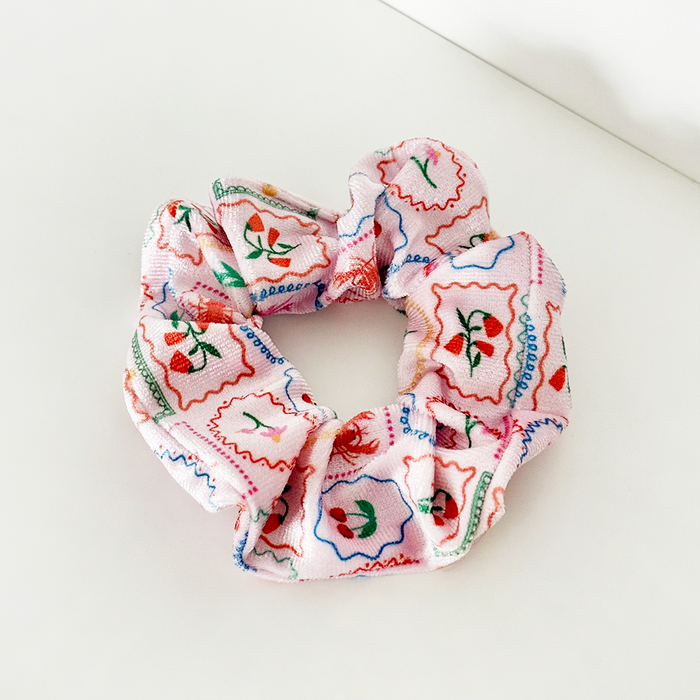 Pink Dolce Vita scrunchie by Coconut Lane with colorful floral and stamp pattern on soft fabric.