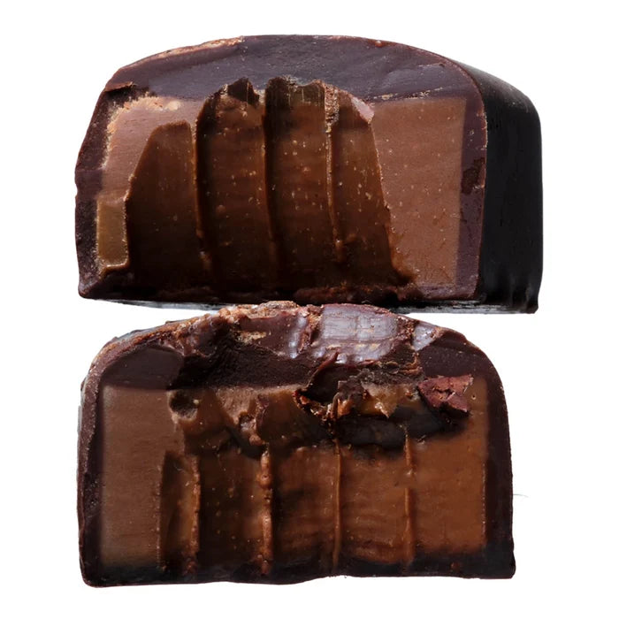 Double chocolate truffle halved and stacked on top of each other showing filling & texture.