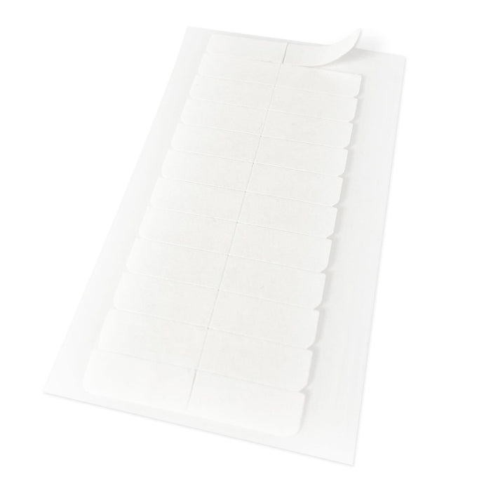 A sheet of rectangular self-adhesive labels with rounded corners, one partially peeled back, rests on a white surface.