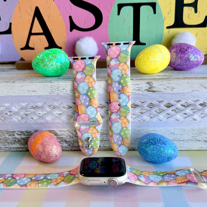 Egg-stra Cute Apple Watch band with colorful pastel Easter eggs displayed with glittery eggs and Easter decorations
