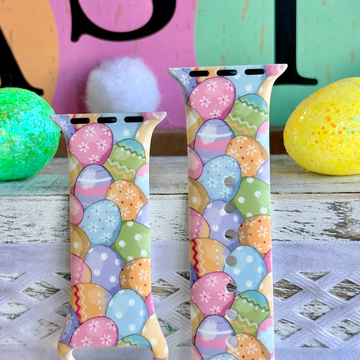 Egg-stra Cute Apple Watch band with colorful pastel Easter eggs displayed with glittery eggs and Easter decorations