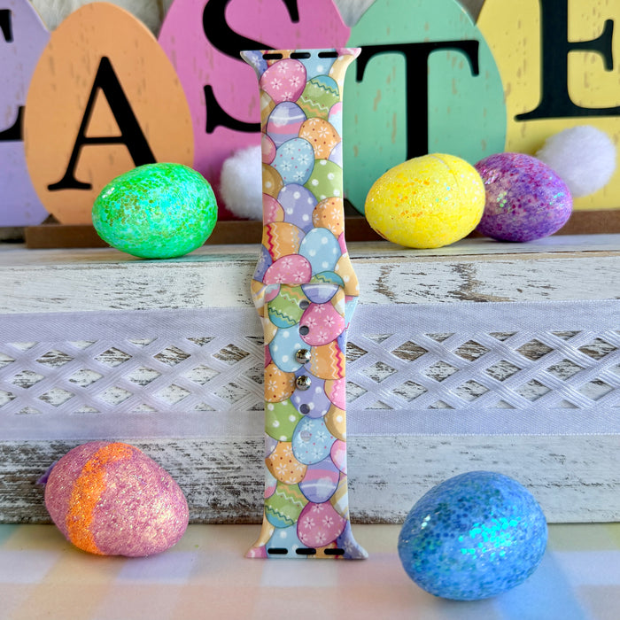 Egg-stra Cute Apple Watch band with colorful pastel Easter eggs displayed with glittery eggs and Easter decorations