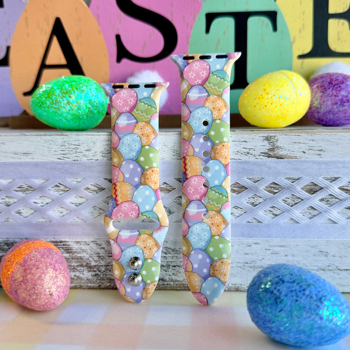 Egg-stra Cute Apple Watch band with colorful pastel Easter eggs displayed with glittery eggs and Easter decorations
