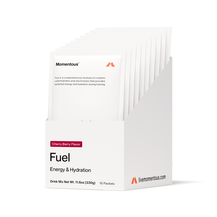 White plastic container labeled “Momentous Fuel – Carbohydrates & Electrolytes” in Cherry Berry flavor. Text states that Fuel is a comprehensive formula of carbohydrates and electrolytes that provides sustained energy and hydration during training. Net weight: 11.6 oz (330 g).