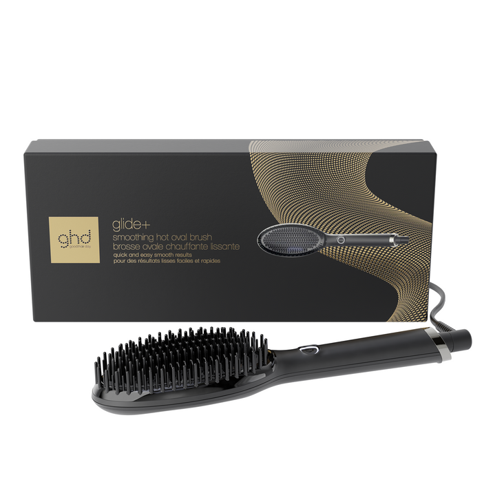 Black hairbrush with packaging on a white background