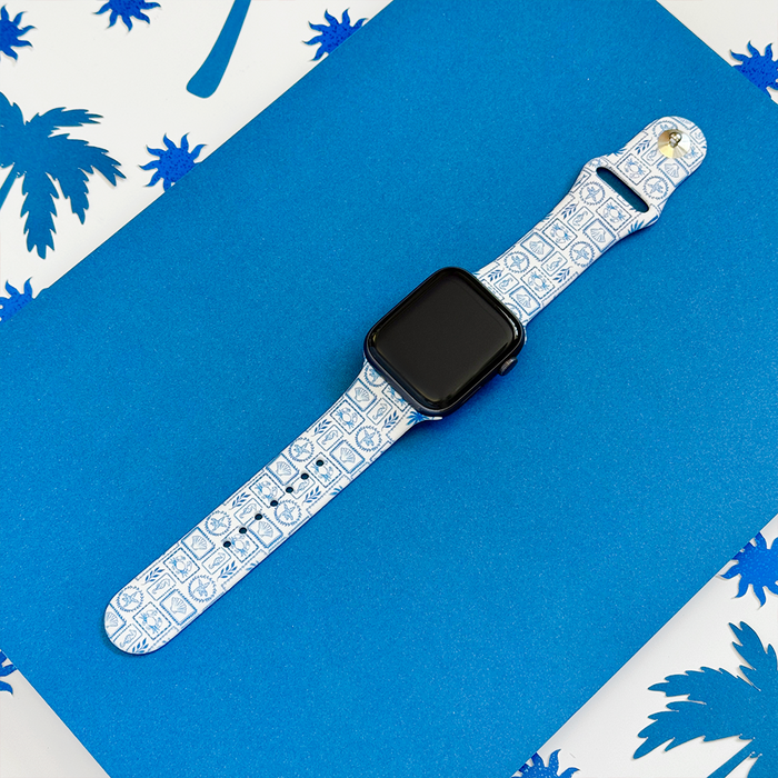 Blue and white Apple Watch strap with a palm tree pattern.