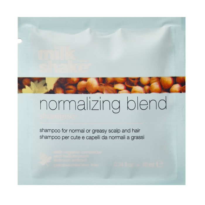 Shampoo packet labeled milk_shake 'normalizing blend' with a background of nuts.
