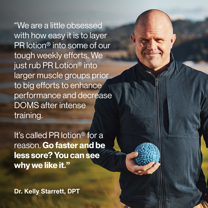Dr. Kelly Starrett standing outdoors holding a blue massage ball. Text reads: “We are a little obsessed with how easy it is to layer PR lotion® into some of our tough weekly efforts. We just rub PR Lotion® into larger muscle groups prior to big efforts to enhance performance and decrease DOMS after intense training. It’s called PR lotion® for a reason. Go faster and be less sore? You can see why we like it.” Attribution reads: “Dr. Kelly Starrett, DPT.”