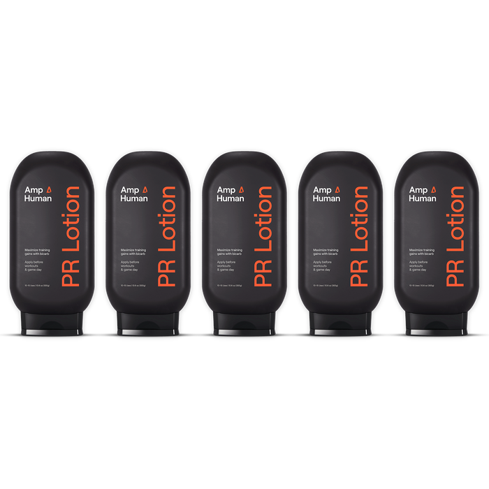 Five black Amp Human PR Lotion bottles displayed side by side on a transparent background. Each bottle label reads: “Amp Human®,” “PR Lotion®,” “Sports lotion with bicarb,” and “10–15 Uses 10.6 oz (300g).”