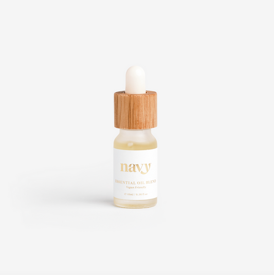 A small clear glass bottle with a dropper. Essential oil, with a wooden cap. Navy Siganture scent