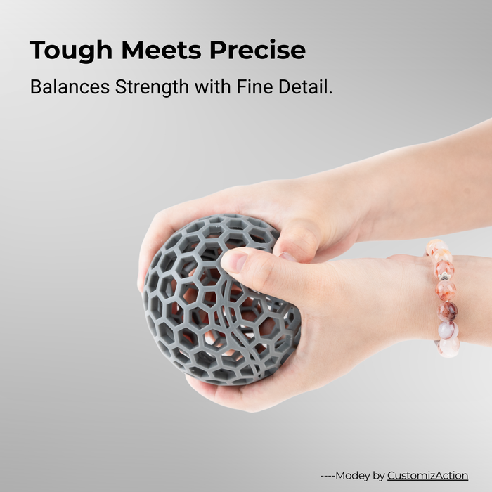 durable resin grey 3D printed honeycomb sphere held in two hands tough precise detail