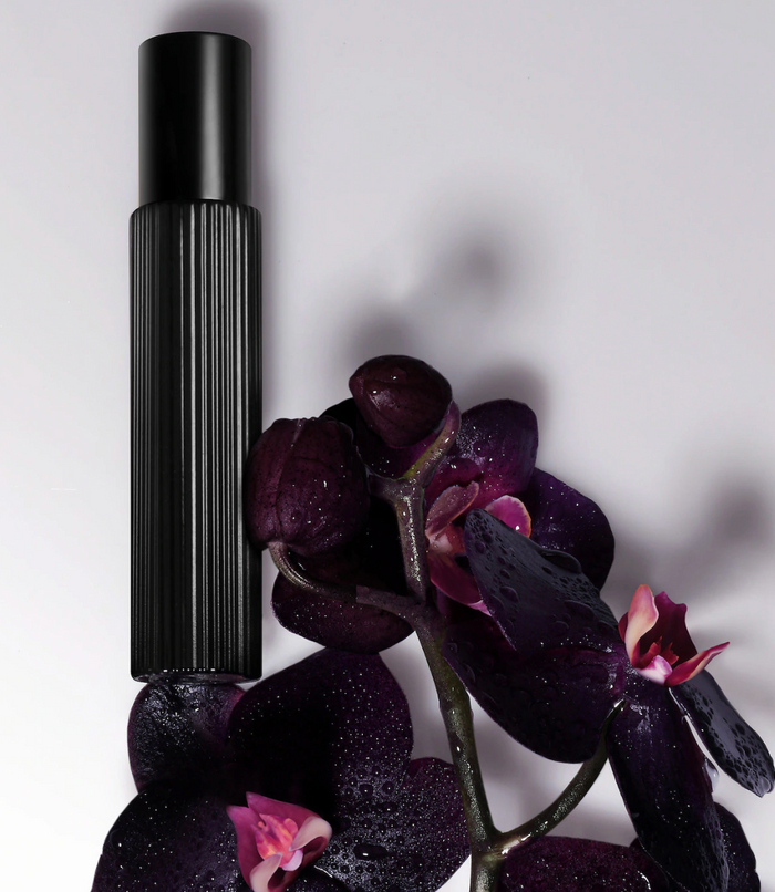 Tom Ford Black Orchid Eau de Parfum travel spray featuring black truffle and ylang ylang, showcasing elegant fragrance packaging.