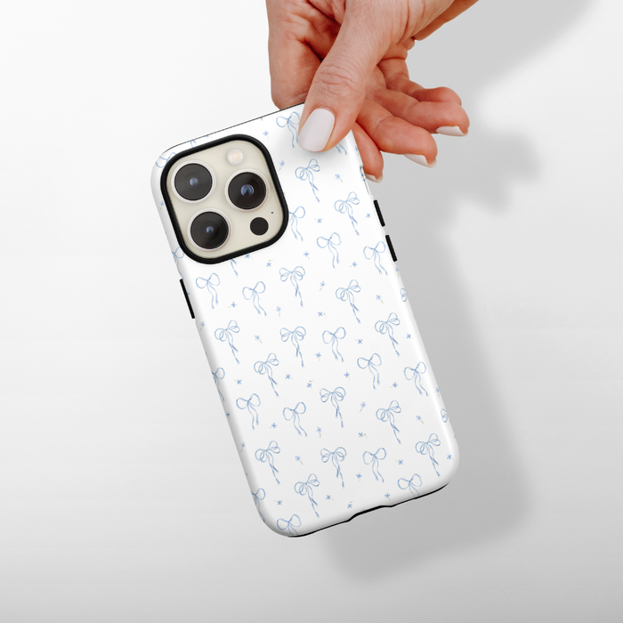 Bluebell Bows Coconut Lane Tough Phone Case held in hand, shown against a simple plain background.