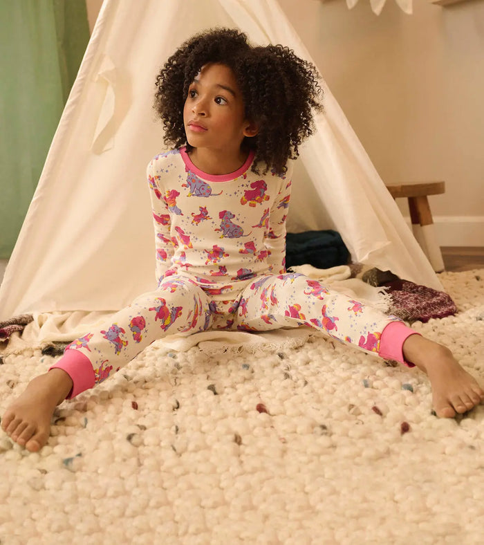 Girl wearing Hatley Twinkle Puppies pajamas with soft organic cotton and snug-fitting comfort.