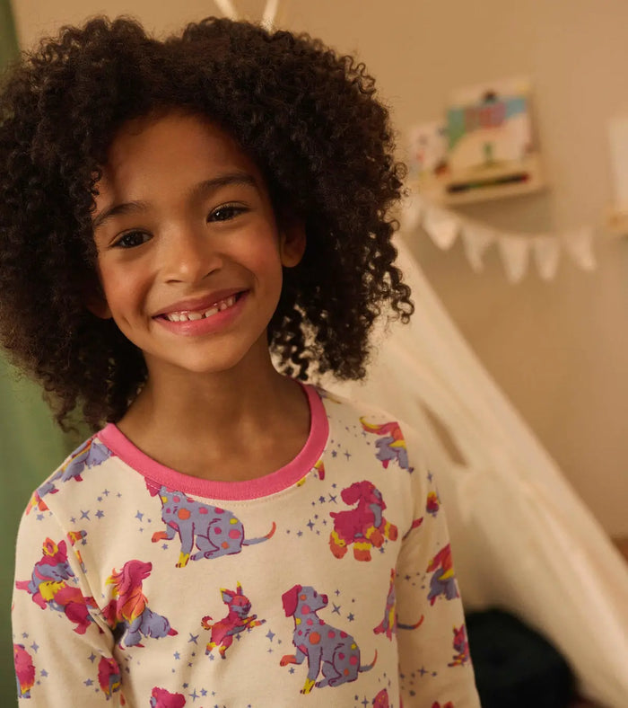 Closeup of Hatley girls puppy pajama top showing pink neckline and OCS organic cotton fabric.
