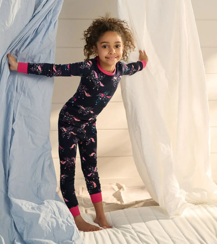 Girl wearing Hatley Unicorn Constellations pajamas with soft organic cotton and snug-fitting design.