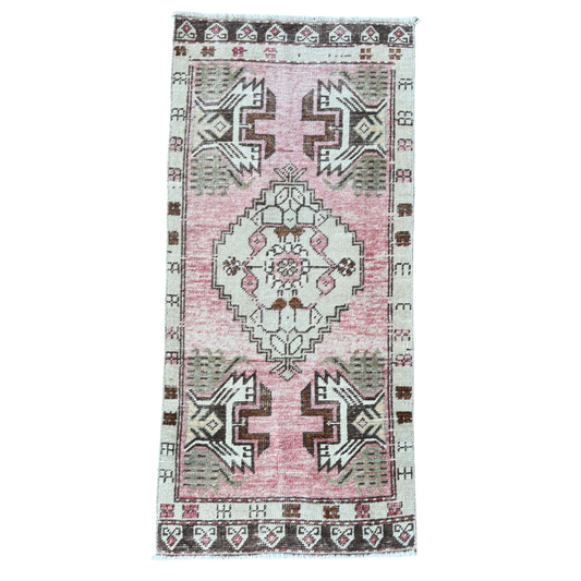 Vintage-style rug with geometric pattern on a white background