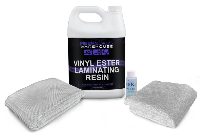 White gallon jug of vinyl ester laminating resin in the middle of folded fiberglass cloth, catalyst and folded chopped strand mat.