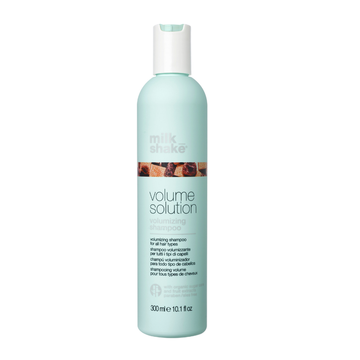 Mint green shampoo bottle with milk_shake  volumising shampoo branding on a white background