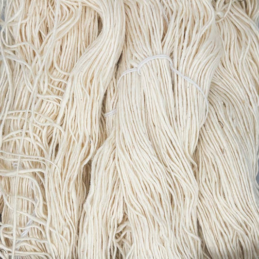 Close up of off-white yarn showing fiber and size of strand.